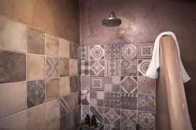 a bathroom with a shower with a towel hanging on the wall at Villa Christini in Kissamos