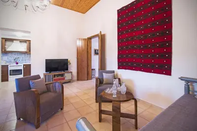 a living room with two chairs and a table at Villa Christini in Kissamos