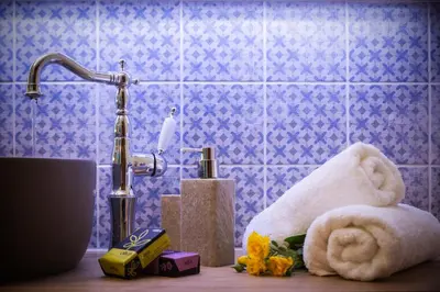 a bathroom with a sink with a towel and a faucet at Villa Christini in Kissamos