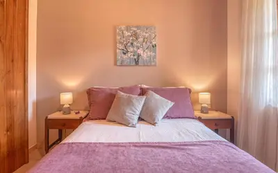 a bedroom with a purple bed with two night stands at Villa Christini in Kissamos