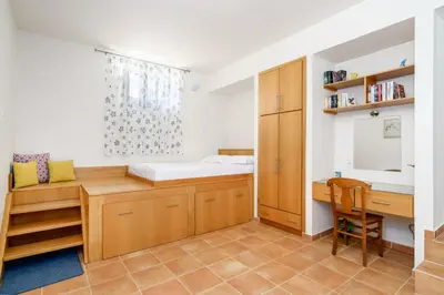 a small room with a bed and a desk at Stone Built Private villa Emerald with pool, 30m to Beach & BBQ! in Ropanianá