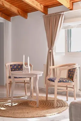 a living room with a table and two chairs at Villa Felenia in Vryses