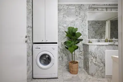 a bathroom with a washing machine and a sink at Villa Felenia in Vryses