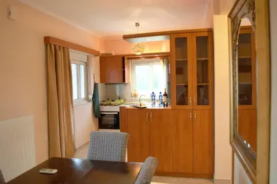 a kitchen with a table and a kitchen with a counter at Angellinas Apartments in Kato Daratso