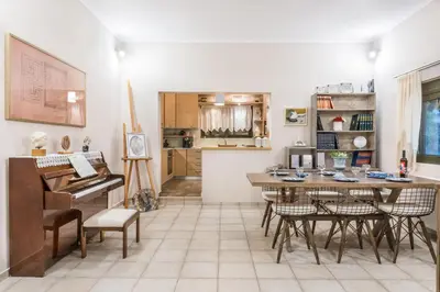 a living room with a piano and a table and chairs at Aoria Villa By Hope Estate in Arménoi