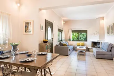 a living room with a table and a couch at Aoria Villa By Hope Estate in Arménoi