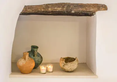 a group of vases and candles on a shelf at Villa Bliss in Kounoupidhianá