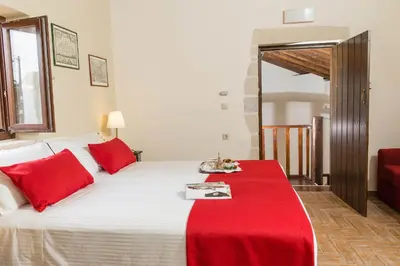 a bedroom with a bed with a red blanket on it at Villa Bliss in Kounoupidhianá