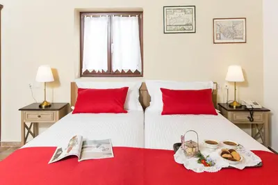 a bedroom with two beds with red pillows at Villa Bliss in Kounoupidhianá