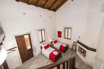 a room with two beds and a staircase in it at Villa Bliss in Kounoupidhianá