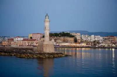 a lighthouse in the middle of a body of water at C&M Residence Chania Old Town in Chania Town