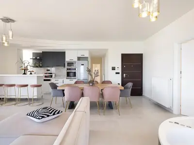 a white kitchen and dining room with a table and chairs at Elia Seaside in Chania Town