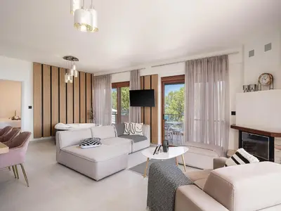 a living room with white furniture and a fireplace at Elia Seaside in Chania Town