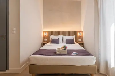 a bedroom with a large bed with a box on it at Porto Orion Studios in Chania Town