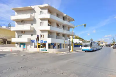 a bus driving down a street in front of a building at Kalamaki Apartments in Kalamaki Chanion