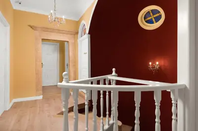 a staircase in a home with orange walls at Cretan Renaissance in Chania Town