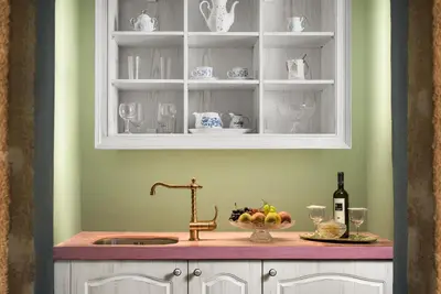 a kitchen with a sink and a cabinet with wine glasses at Cretan Renaissance in Chania Town