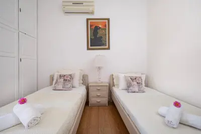 two twin beds in a room with white walls at Irini House in Arménoi