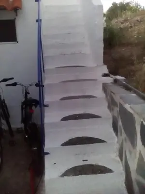 a set of stairs leading up to a building with a bike at Iliana's Bungalow in Arménoi