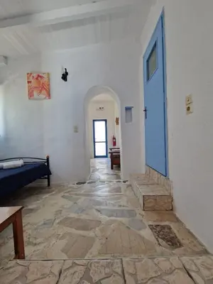 a room with a hallway with a blue door at Iliana's Bungalow in Arménoi