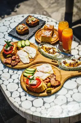 a table with plates of food and drinks on it at Manias Hotel Apartments in Agia Marina Nea Kydonias