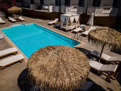 an overhead view of a swimming pool with chairs and umbrellas at Manias Hotel Apartments in Agia Marina Nea Kydonias