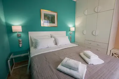 a bedroom with a large bed with towels on it at Horizon Deluxe House in Chania Town