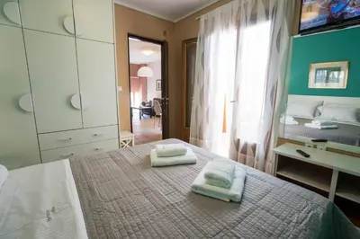 a bedroom with a bed with two towels on it at Horizon Deluxe House in Chania Town