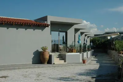 a white house with a porch and a patio at Electra Studios in Gerani Chanion