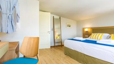 a bedroom with a bed and a desk and a chair at Villa Staride, sea view, private heated pool, playground in Païdhokhórion