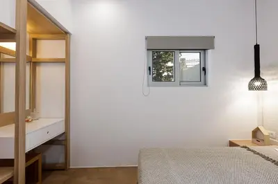 a white bedroom with a bed and a window at Villa Staride, sea view, private heated pool, playground in Païdhokhórion