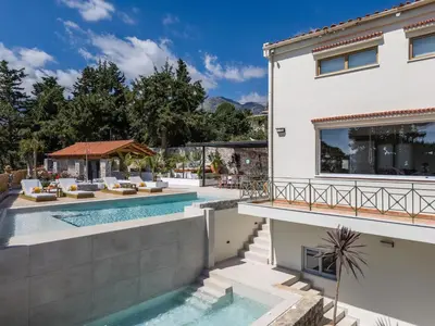 a villa with a swimming pool and a house at Villa Staride, sea view, private heated pool, playground in Païdhokhórion