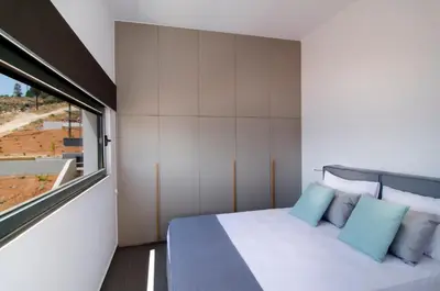 a small bedroom with a bed and a window at Seametry Luxury Living Apartments ADULTS ONLY in Souda