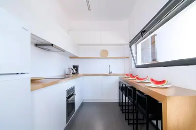 a kitchen with a counter with watermelon plates on it at Seametry Luxury Living Apartments ADULTS ONLY in Souda