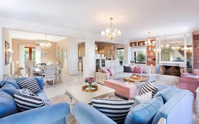 a living room with blue and pink furniture at Villa Vanelia Mare in Kalamaki Chanion