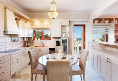 a kitchen with a table and chairs and a dining room at Villa Vanelia Mare in Kalamaki Chanion