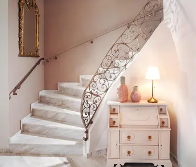 a staircase in a home with a dresser and a stair railing at Villa Vanelia Mare in Kalamaki Chanion