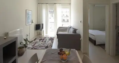 a living room with a bed and a table with a bowl of fruit at Christini Apartment in Chania Town