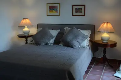 a bedroom with a bed with two lamps on two tables at Ktima Grammeno Beachside Villa in Palaiochóra