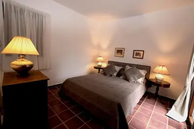 a bedroom with a bed and two lamps in it at Ktima Grammeno Beachside Villa in Palaiochóra