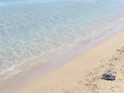 a pair of flip flops sitting on the beach at Ktima Grammeno Beachside Villa in Palaiochóra