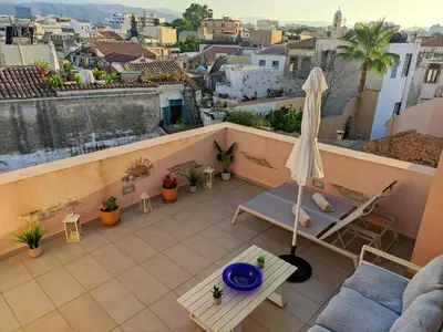 an overhead view of a balcony with an umbrella at Odyssey Studios in Chania Town