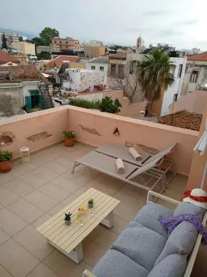 a balcony with a table and a view of a city at Odyssey Studios in Chania Town