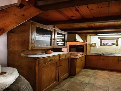 a kitchen with wooden cabinets and a counter top at Villa in Crete with Vineyard Experience in Kalamítsion Alexándrou