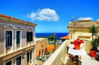 a balcony with a view of the ocean from a building at Hera Studios in Chania Town