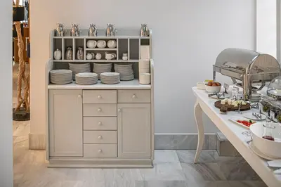 a cabinet with plates and dishes on top of it at Avra City Boutique Hotel in Chania Town