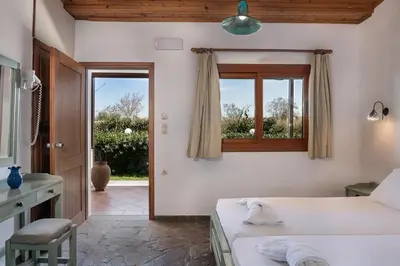 a bedroom with two beds and a window at Androulakis Apartments in Gerani Chanion