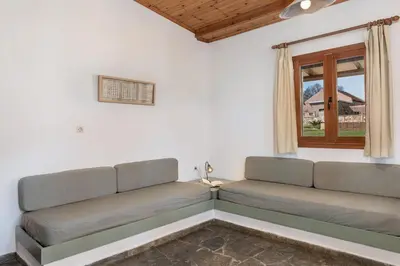 a couch in a room with a window at Androulakis Apartments in Gerani Chanion