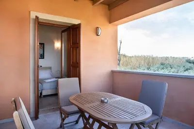 a table and chairs in a room with a window at Androulakis Apartments in Gerani Chanion