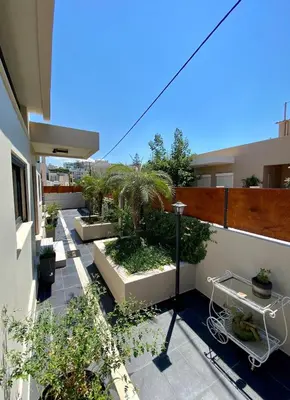 an apartment patio with potted plants on a balcony at Golden View Villa in Kato Daratso